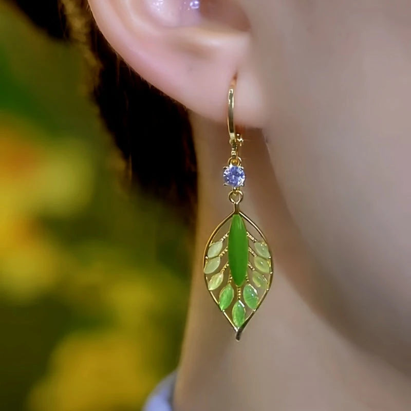 Model showcasing the dangle and style of the 14K Gold-Plated Elegant Zircon Crystal Leaf Earrings