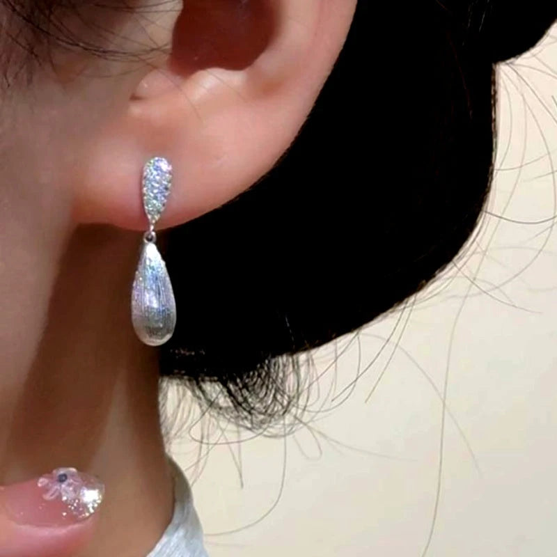 Close-up detail of the sparkling zircons and plating on the Pave Teardrop Earrings