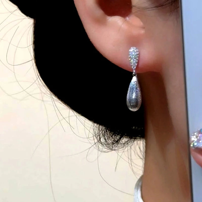 Model showcasing the dangle and style of the 14K Gold-Plated Elegant Zircon DIamond Water Drop Earrings