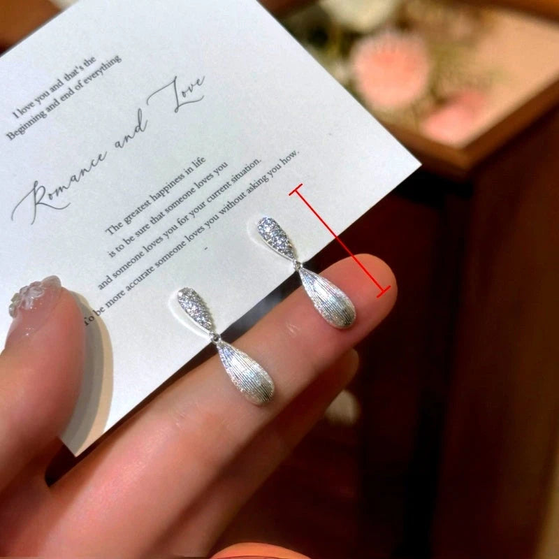 Angled view of the 14K Gold-Plated Elegant Zircon DIamond Water Drop Earrings