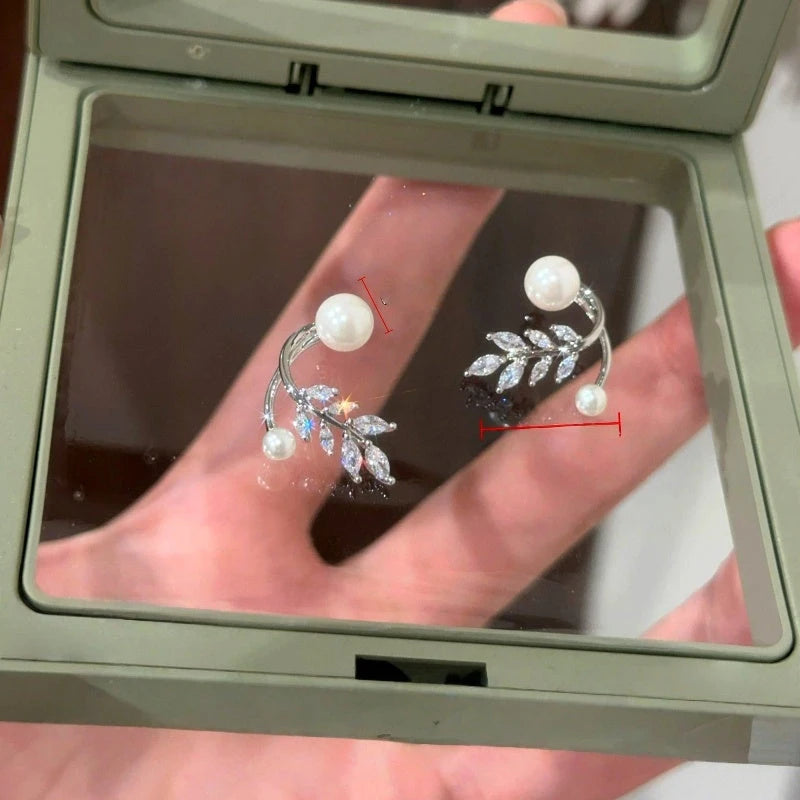 Model showcasing the dangle and style of the 14K Gold-Plated Elegant Zircon DIamond Wheat Pearl Jacket Earrings