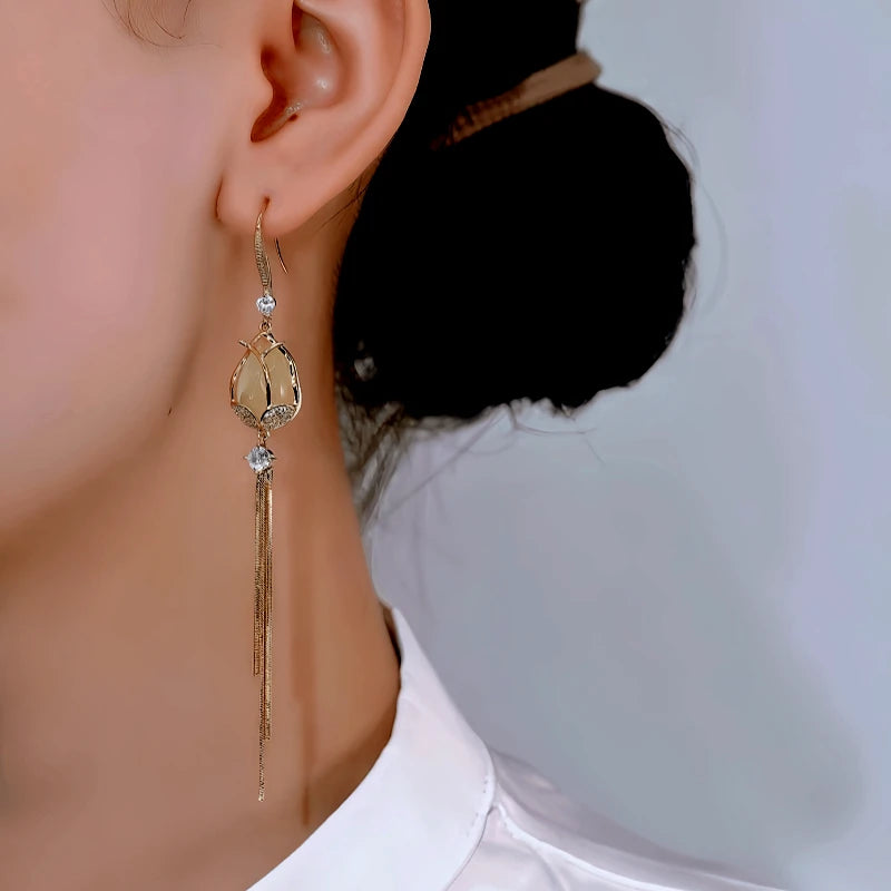 Model showcasing the dangle and style of the 14K Gold-Plated Elegant Zircon Diamod Tulip Ear Hook Tassel Earrings