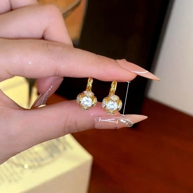 Model showcasing the dangle and style of the 14K Gold-Plated Elegant Zircon Diamond Ball Earrings
