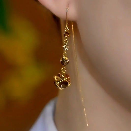 Model showcasing the dangle and style of the 14K Gold-Plated Elegant Zircon Diamond Ball Threader Earrings