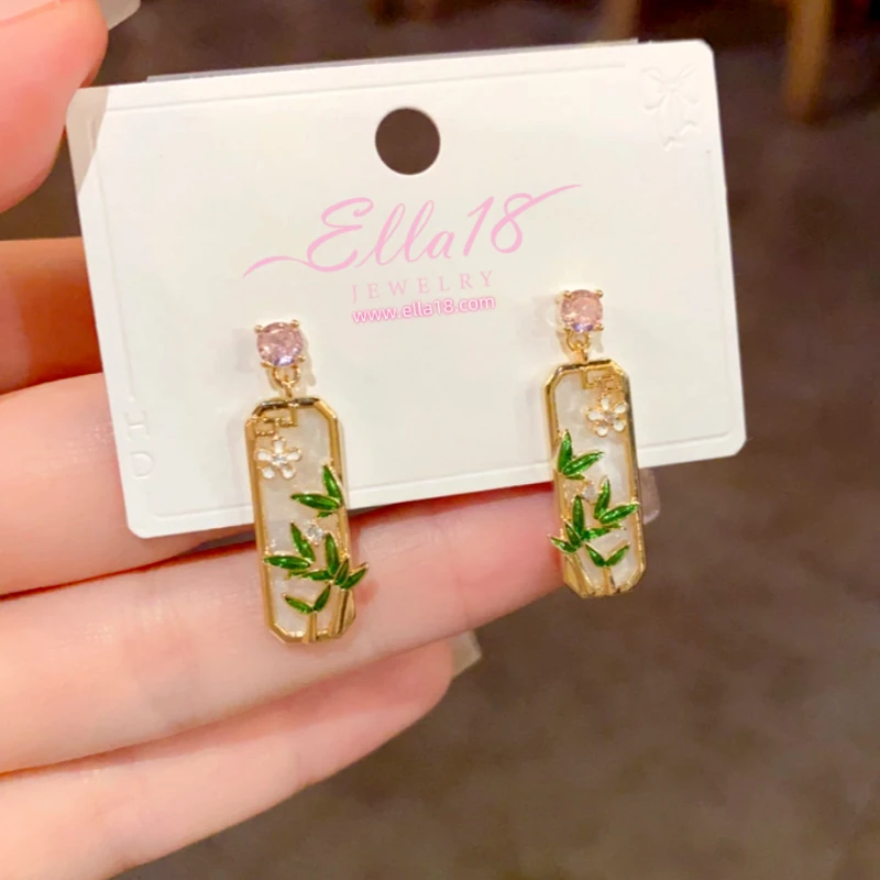 Model showcasing the dangle and style of the 14K Gold-Plated Elegant Zircon Diamond Bamboo Leaf Earrings