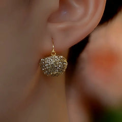 Model showcasing the dangle and style of the 14K Gold-Plated Elegant Zircon Diamond Basket Earrings