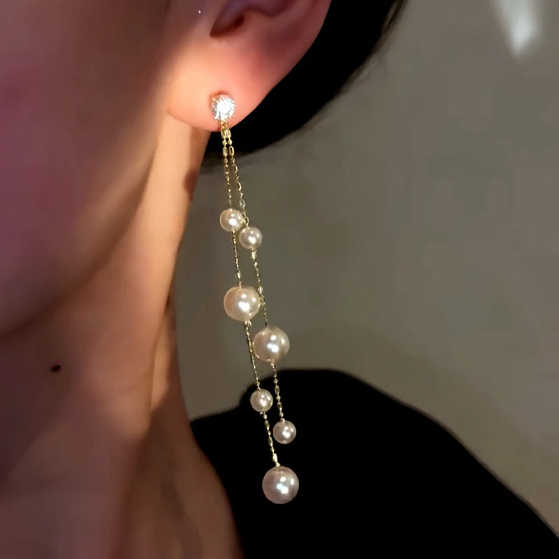 Model showcasing the dangle and style of the 14K Gold-Plated Elegant Zircon Diamond Bead Tassel Earrings