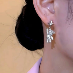 Model showcasing the dangle and style of the 14K Gold-Plated Elegant Zircon Diamond Bear Star Tassel Earrings