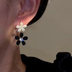 Model showcasing the dangle and style of the 14K Gold-Plated Elegant Zircon Diamond Black Flower Earrings