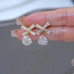 Angled view of the 14K Gold-Plated Elegant Zircon Diamond Bow Ball Earrings