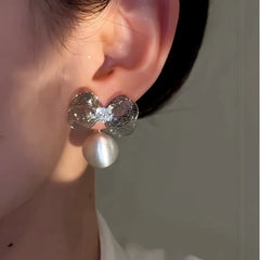 Model showcasing the dangle and style of the 14K Gold-Plated Elegant Zircon Diamond Bow Brushed Ball Earrings