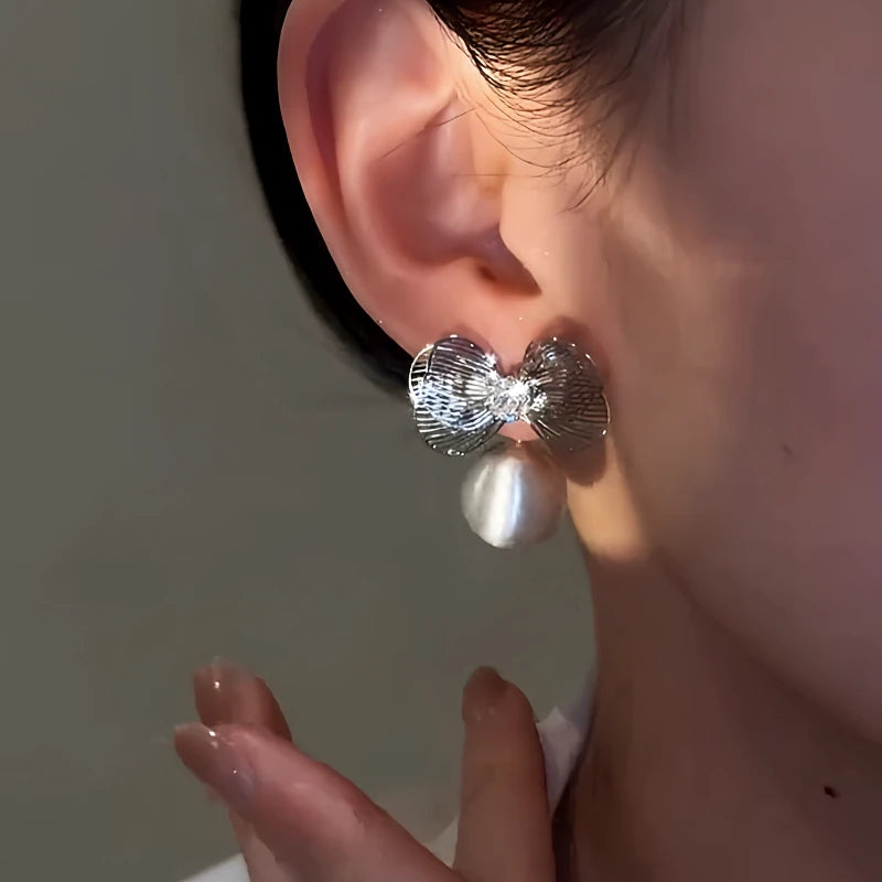 Close-up detail of the sparkling zircons and plating on the Bow Earrings