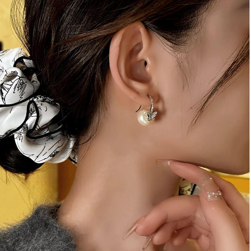 Model showcasing the dangle and style of the 14K Gold-Plated Elegant Zircon Diamond Butterfly Bead Ear Hook Earrings