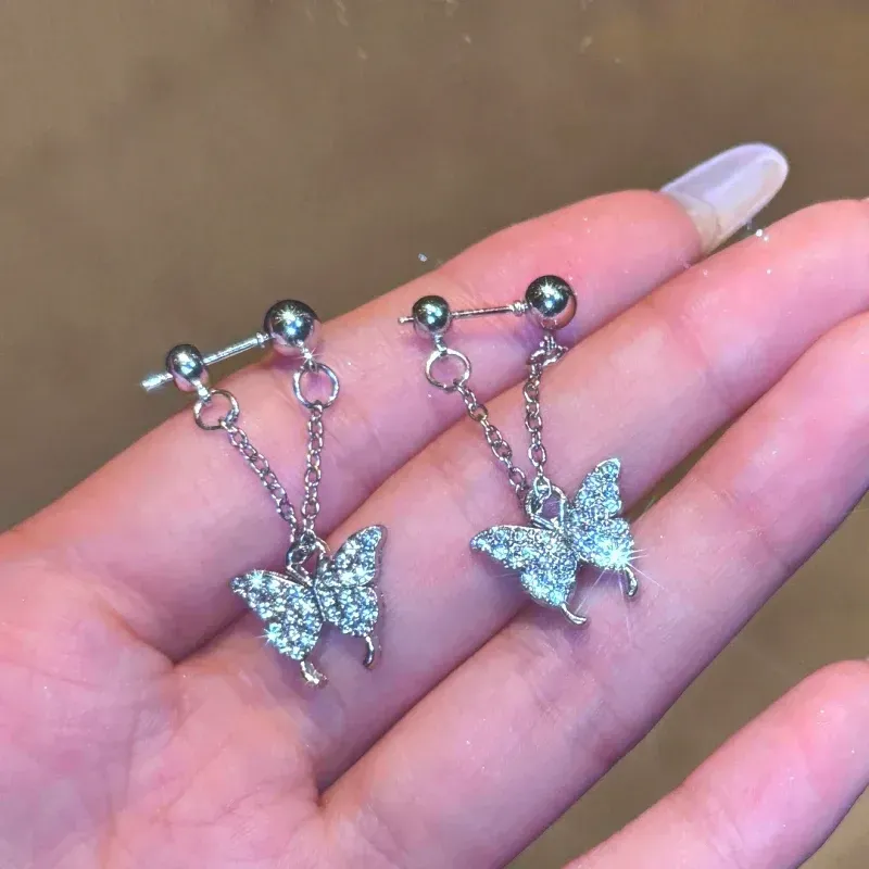 Model showcasing the dangle and style of the 14K Gold-Plated Elegant Zircon Diamond Butterfly Tassel Earrings