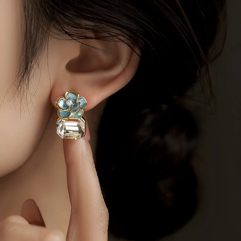 Model showcasing the dangle and style of the 14K Gold-Plated Elegant Zircon Diamond Camellia Flower Earrings