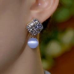 Close-up detail of the sparkling zircons and plating on the Cat's Eye Bead Earrings