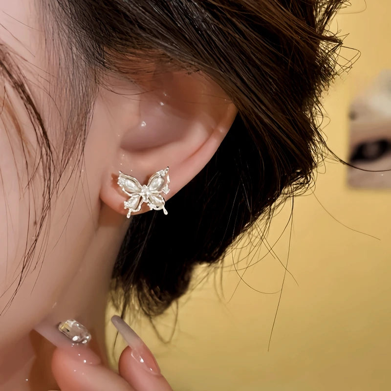 Model showcasing the dangle and style of the 14K Gold-Plated Elegant Zircon Diamond Cat's Eye Stone Butterfly Stud Earrings