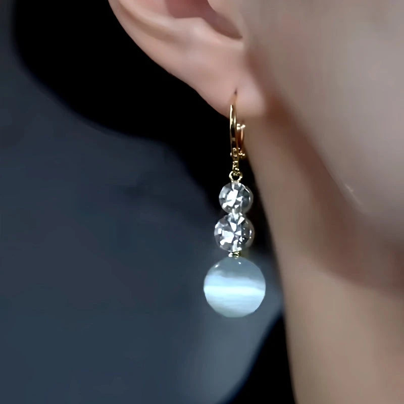 Model showcasing the dangle and style of the 14K Gold-Plated Elegant Zircon Diamond Cat's Eye Stone Earrings