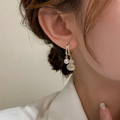 Close-up detail of the sparkling zircons and plating on the Gourd Earrings