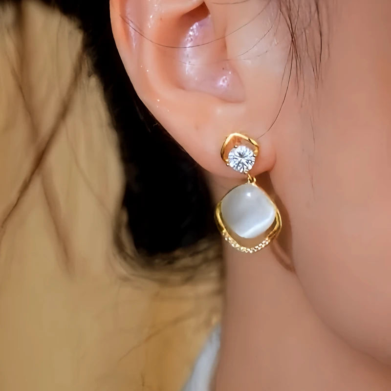 Model showcasing the dangle and style of the 14K Gold-Plated Elegant Zircon Diamond Cat's Eye Stone Tassel Earrings