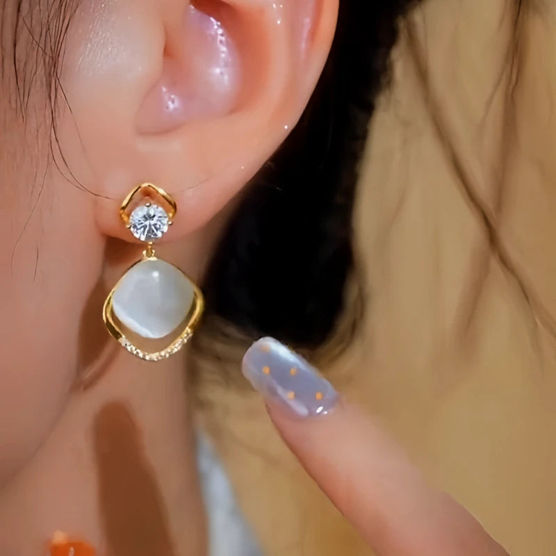 Close-up detail of the sparkling zircons and plating on the Cat's Eye Tassel Earrings