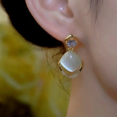 Model showcasing the dangle and style of the 14K Gold-Plated Elegant Zircon Diamond Cat's Eye Stone Water Drop Earrings