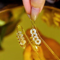 Close-up detail of the sparkling zircons and plating on the Tassel Threader Earrings