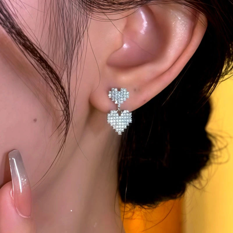 Model showcasing the dangle and style of the 14K Gold-Plated Elegant Zircon Diamond Double-Layer Bling Heart Earrings