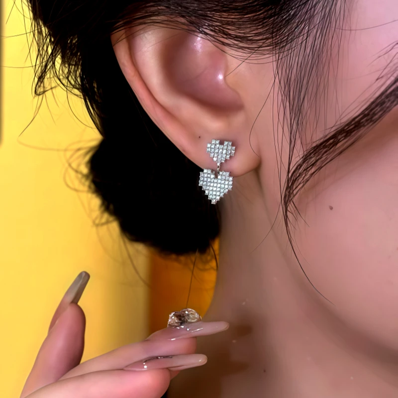 Close-up detail of the sparkling zircons and plating on the Heart Earrings