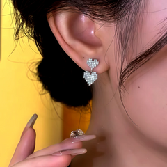 Close-up detail of the sparkling zircons and plating on the Heart Earrings