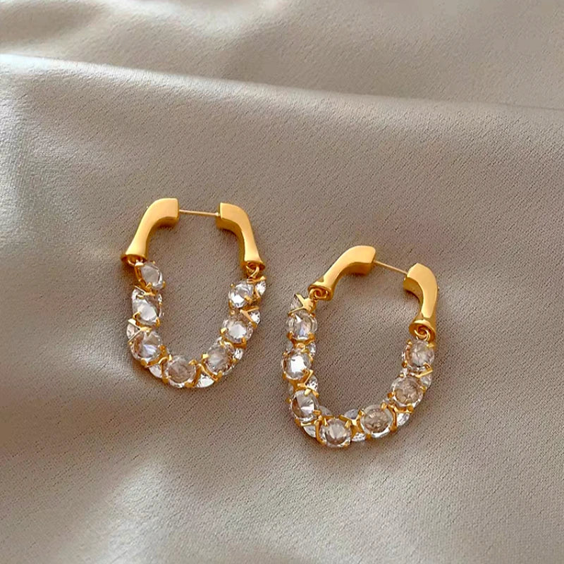 Model showcasing the dangle and style of the 14K Gold-Plated Elegant Zircon Diamond Earrings
