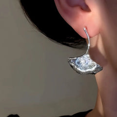 Model showcasing the dangle and style of the 14K Gold-Plated Elegant Zircon Diamond Fan-Shaped Earrings