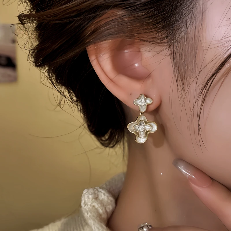 Model showcasing the dangle and style of the 14K Gold-Plated Elegant Zircon Diamond Flower Earrings