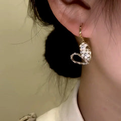 Close-up detail of the sparkling zircons and plating on the Flower Heart Earrings