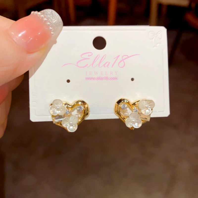 Model showcasing the dangle and style of the 14K Gold-Plated Elegant Zircon Diamond Flower Heart Stud Earrings