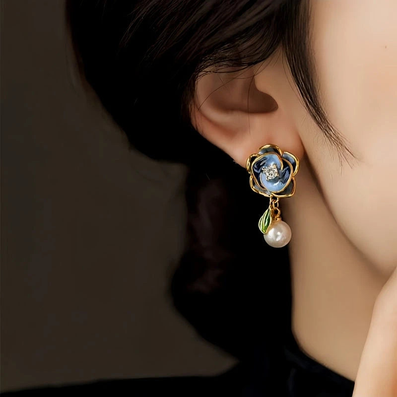 Model showcasing the dangle and style of the 14K Gold-Plated Elegant Zircon Diamond Flower Pearl Earrings