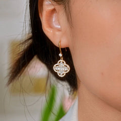 Model showcasing the dangle and style of the 14K Gold-Plated Elegant Zircon Diamond Four-Leaf Ear Hook Earrings