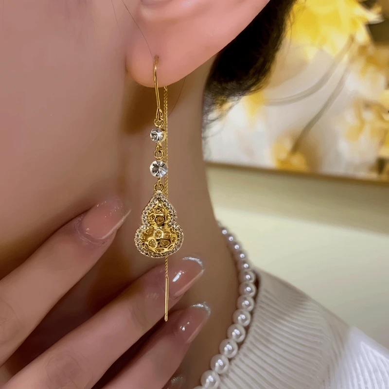 Close-up detail of the sparkling zircons and plating on the Gourd Threader Earrings