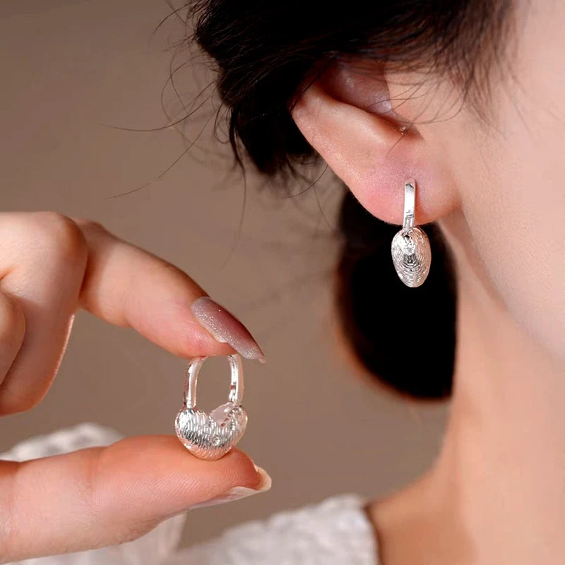 Close-up detail of the sparkling zircons and plating on the Gold Heart Earrings