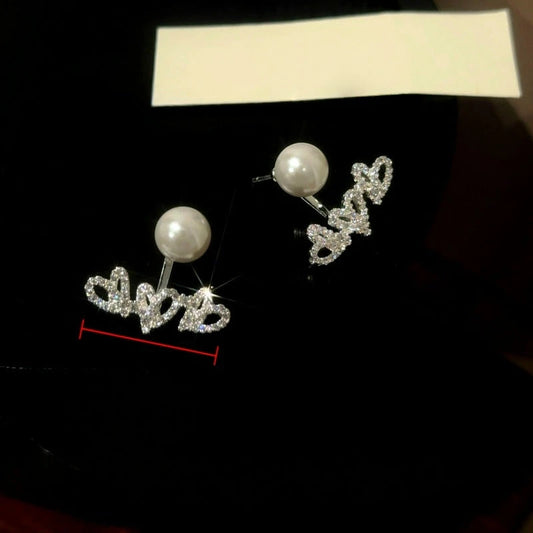 Model showcasing the dangle and style of the 14K Gold-Plated Elegant Zircon Diamond Heart Pearl Jacket Earrings