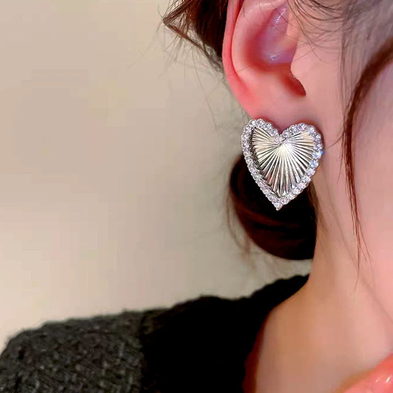 Close-up detail of the sparkling zircons and plating on the Heart Earrings