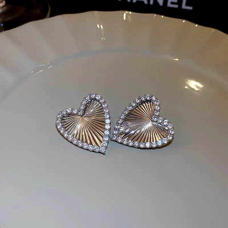 Angled view of the 14K Gold-Plated Elegant Zircon Diamond Heart Stud Earrings