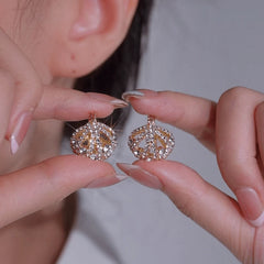 Close-up detail of the sparkling zircons and plating on the Cradle Earrings