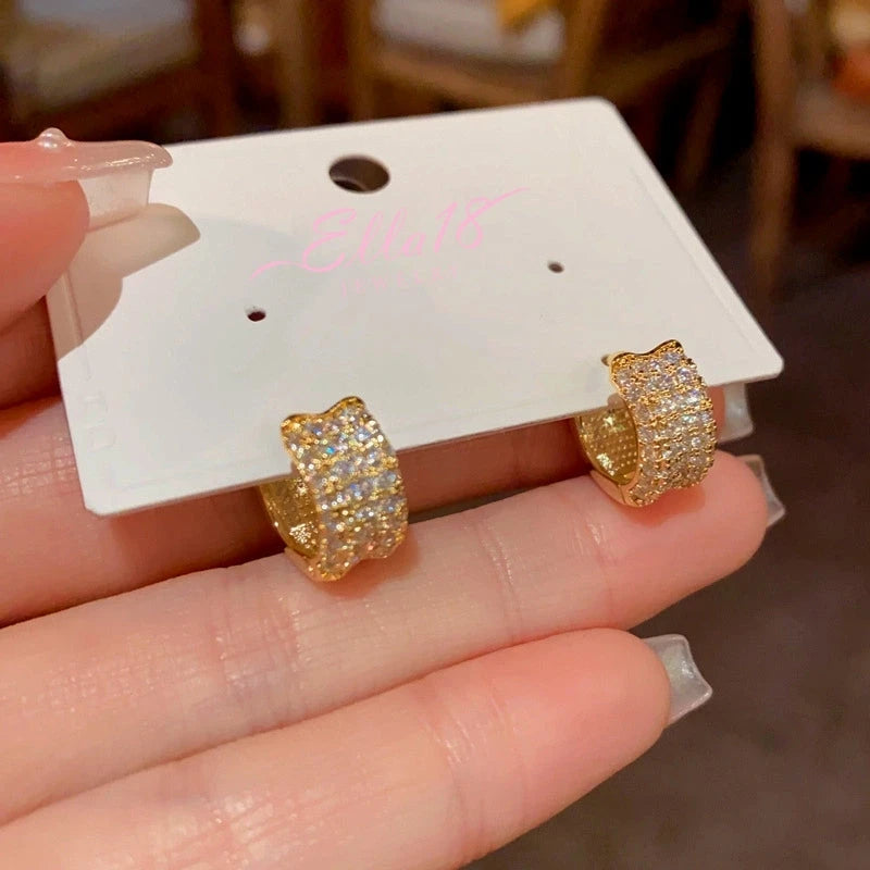 Model showcasing the dangle and style of the 14K Gold-Plated Elegant Zircon Diamond Hoop Earrings