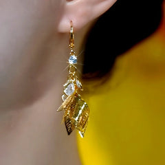 Model showcasing the dangle and style of the 14K Gold-Plated Elegant Zircon Diamond Jade Leaf Earrings