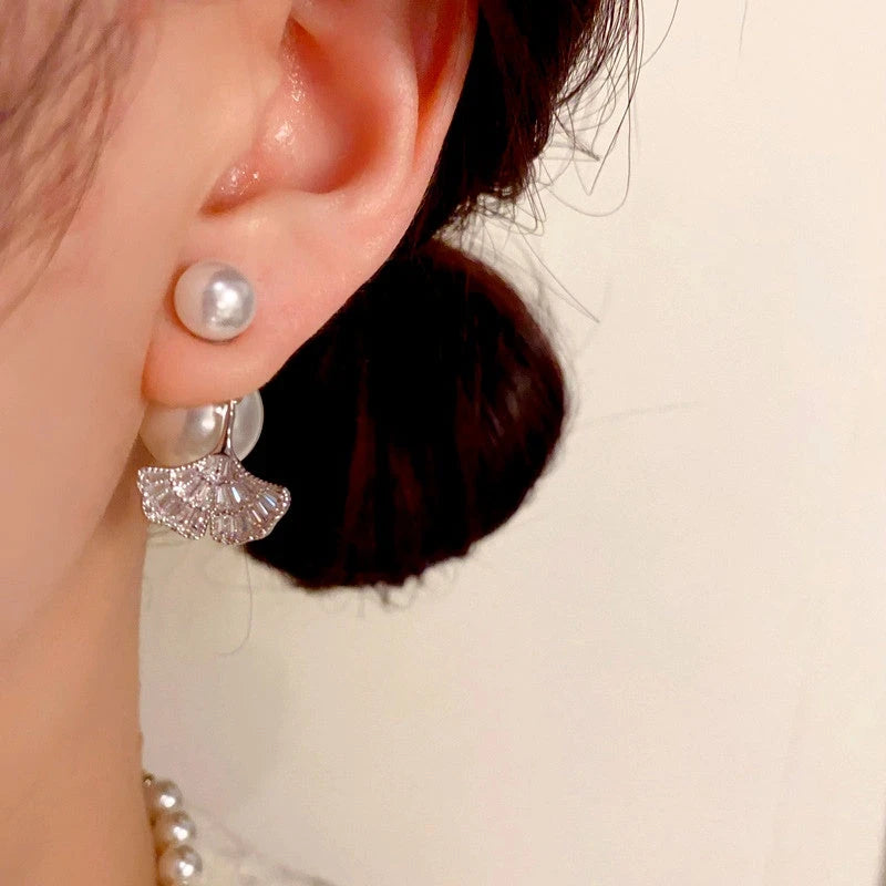 Angled view of the 14K Gold-Plated Elegant Zircon Diamond Leaf Pearl Jacket Earrings