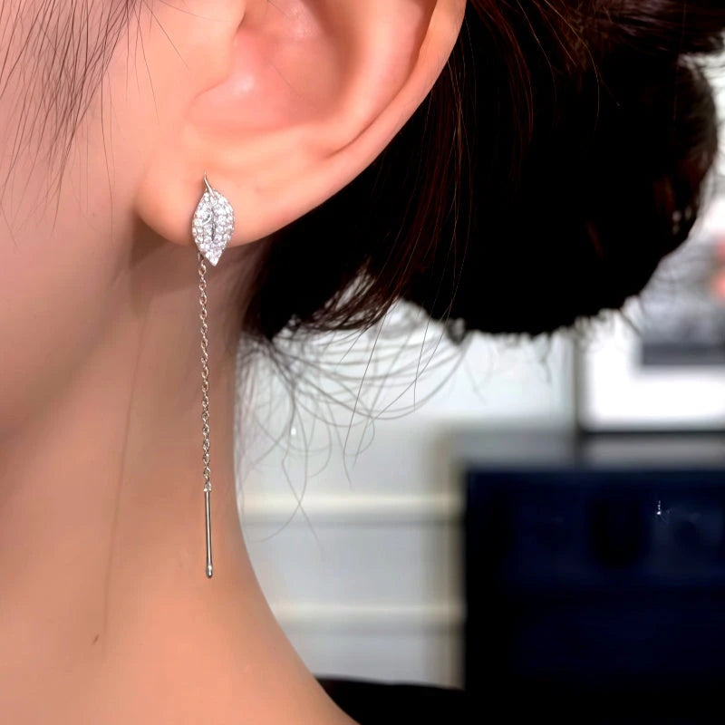 Model showcasing the dangle and style of the 14K Gold-Plated Elegant Zircon Diamond Leaf Threader Earrings