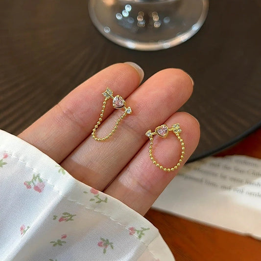 Model showcasing the dangle and style of the 14K Gold-Plated Elegant Zircon Diamond Match Sword Earrings