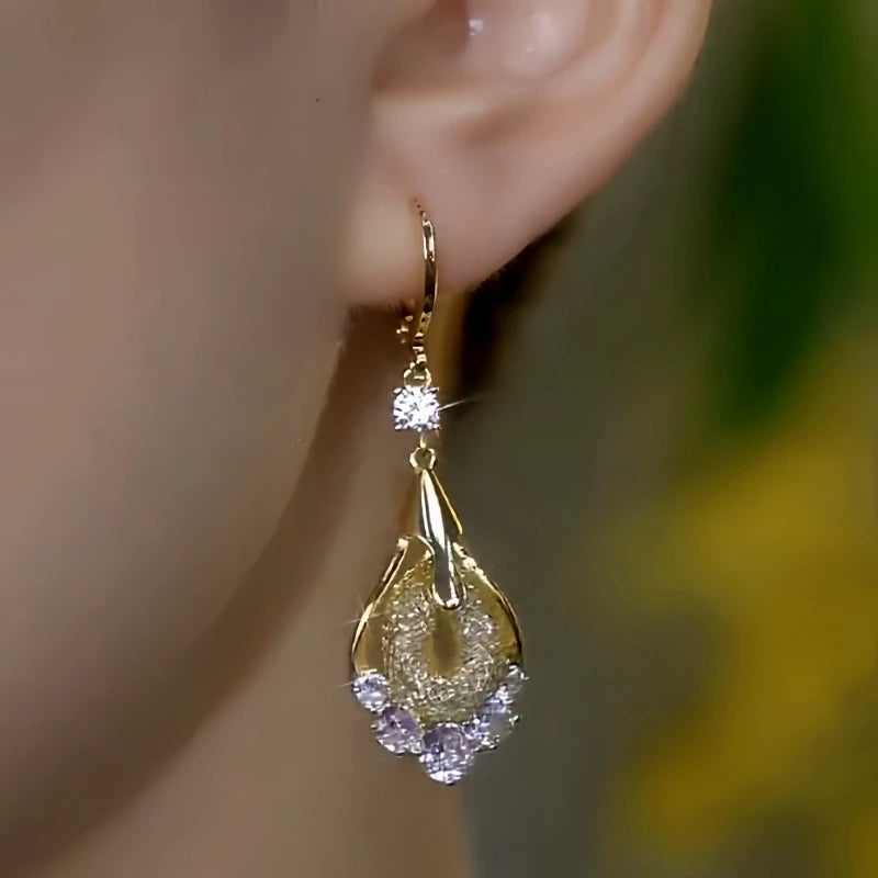 Model showcasing the dangle and style of the 14K Gold-Plated Elegant Zircon Diamond Mesh Water Drop Earrings