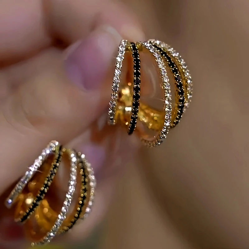 Model showcasing the dangle and style of the 14K Gold-Plated Elegant Zircon Diamond Multi-Layer Hoop Earrings